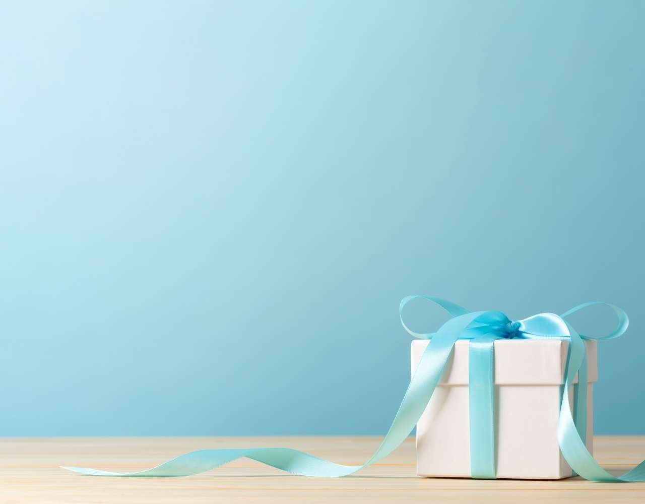 a blue background with an elegant gift box