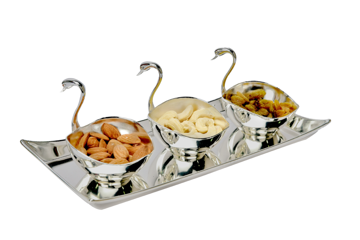 a set of three swan shaped bowls placed on a silver tray