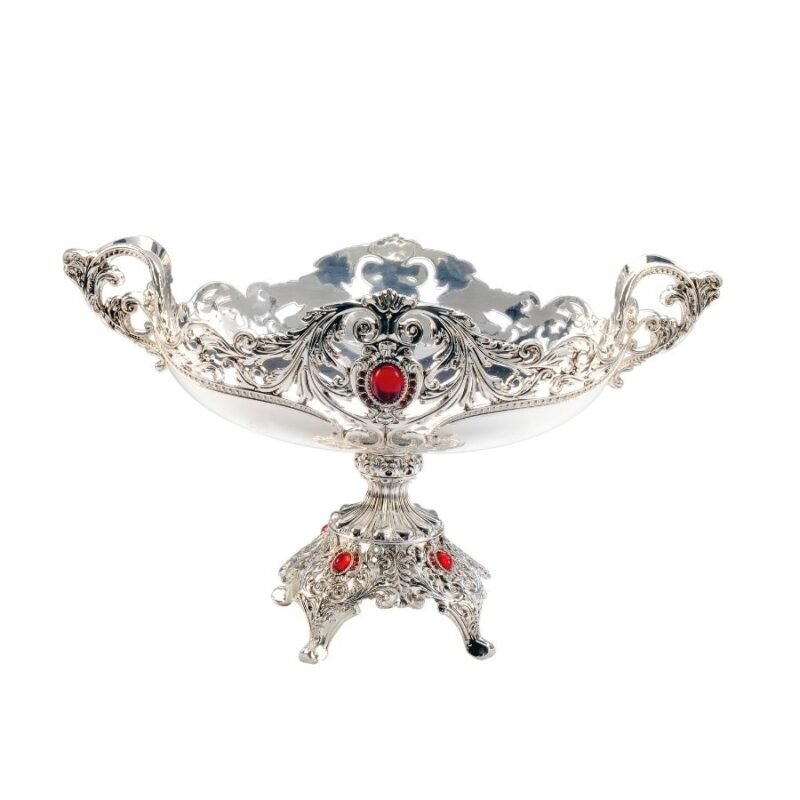 an amazing oval silver bowl styled antiquely with intricate designs on an elegant pedestal & red stones throughout