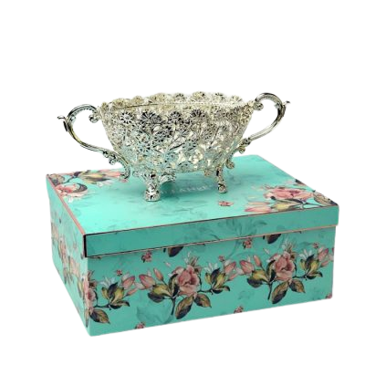 oval shaped silver plated bowl with handle placed on a gift box