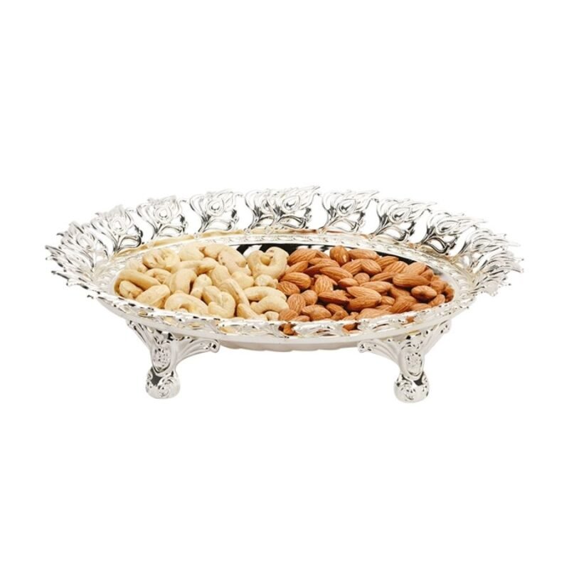 a unique silver bowl of peacock leaf motif around the border and designer legs with dryfruits kept in it