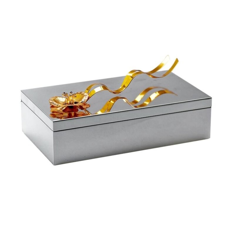 a beautiful rectangular silver box with a golden flower adornment on the top