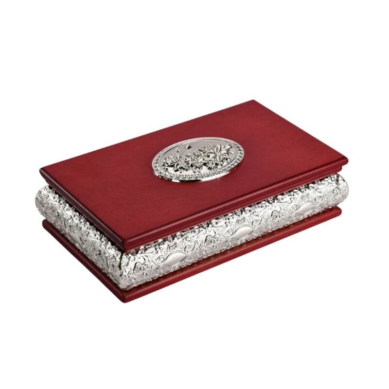 A red wooden box in rectangular shape with silver work done on its lid and on the borders that make it unique