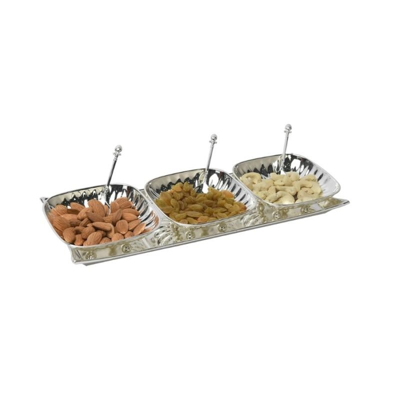 a captivating set of three silver bowls and sleek spoons holding dry fruits kept on a classy silver tray