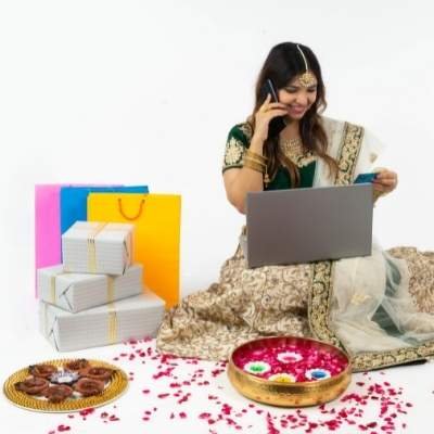 a picture of a girl in ethnic wear sitting with laptop