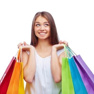 a happy girl holding multiple shopping bags