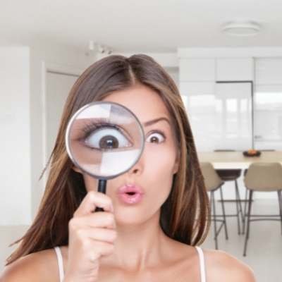 a girl peeping through a magnifying glass