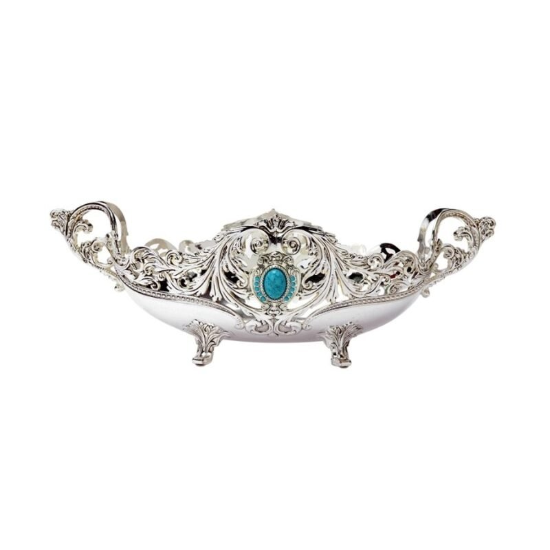 an aladdin lamp's shaped oval silver bowl with intricate designs on the body and a beautiful blue hued stone placed right in the middle