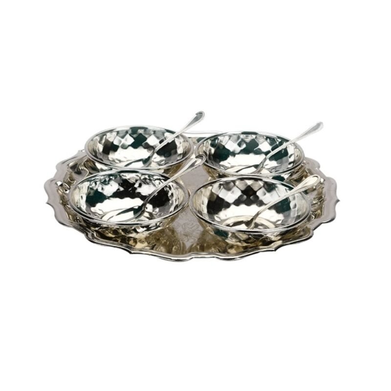 a set of four distinctive hammered silver bowls along with spoons kept on a luxe silver tray