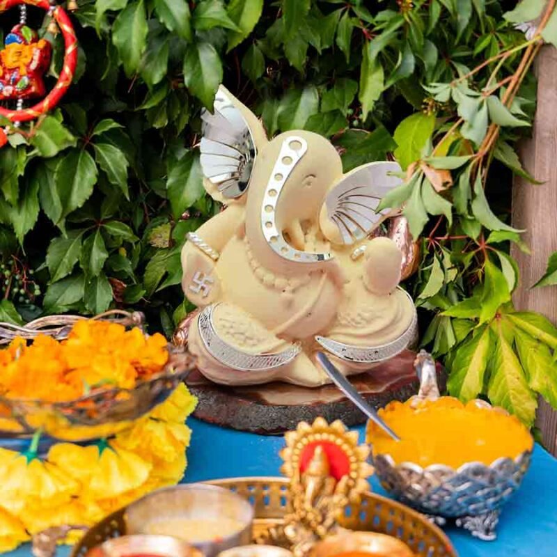 Lord Ganesha Idol On A Platform with pooja items around