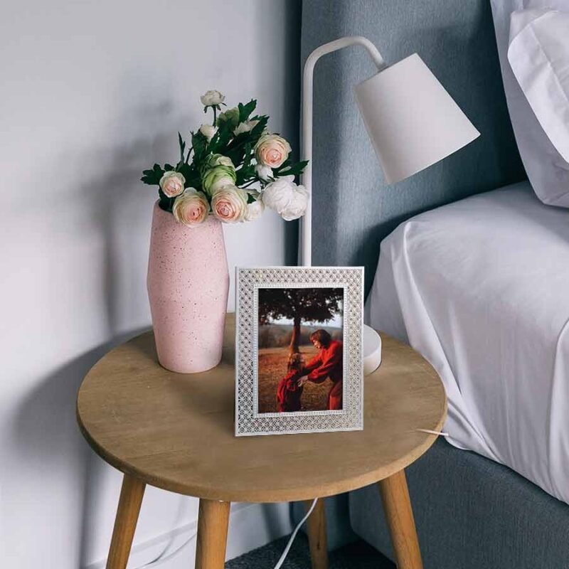 Silver-Plated studded photo frame on bedside table.