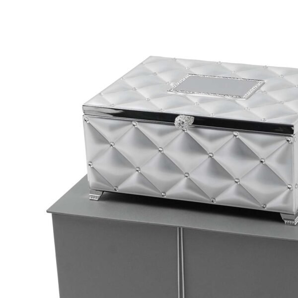 Tufted Design Jewelry Silver Box with Legs and a mirror placed upon a grey box with close up view
