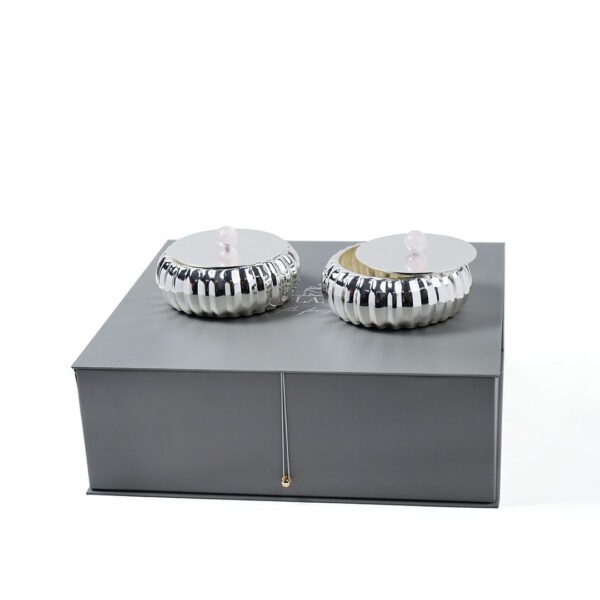Set of Two Ribbed Design Silver Box with Rose Quartz Knob placed upon a grey box