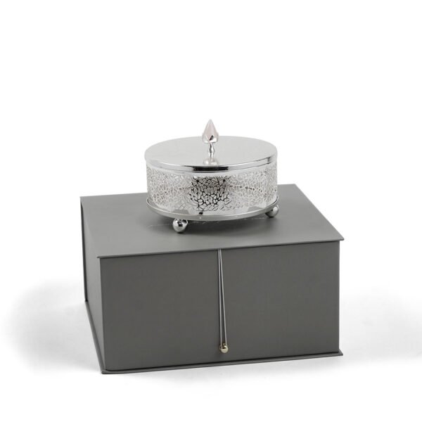 Cutwork Design Round Silver Box with Rose Quartz Knob placed upon its grey box